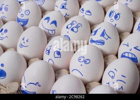 Funny chicken eggs. Smiley eggs with faces, funny faces. Eggs with different emotions: laughter, smiles, fear, anger, scream, tears. Stock Photo