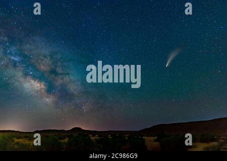 Comet Neowise in starry sky above desert, near Moab Utah, USA Stock Photo