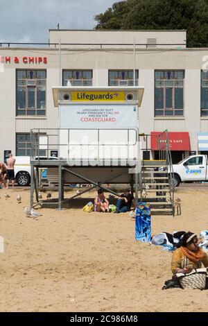 Unattended, closed, shut Lifeguard / Life Guard Station on a fairly busy Bournemouth beach with tourists, bathers and visitors on a sunny summer day. UK (120) Stock Photo