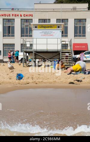 Unattended, closed, shut Lifeguard / Life Guard Station on a fairly busy Bournemouth beach with tourists, bathers and visitors on a sunny summer day. UK (120) Stock Photo