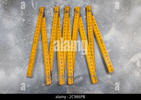 Wooden meter isolated on gray background.Folding wooden Ruler.High resolution photo.