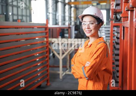 Portrait female engineer standing in factory. Stock Photo