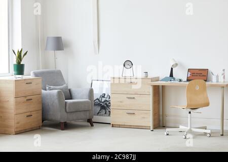 Image of domestic room with laptop on the table and modern furniture Stock Photo