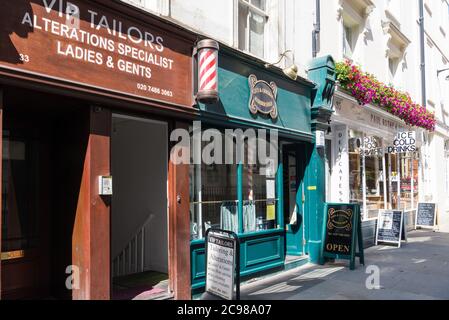 A row of small shops in Marylebone Lane, London, England, UK Stock Photo