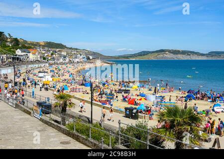 Lyme Regis, Dorset, UK.  29th July 2020.  UK Weather.  The beach is packed with holidaymakers and sunbathers at the seaside resort of Lyme Regis in Dorset on an afternoon of scorching hot sunshine.  Picture Credit: Graham Hunt/Alamy Live News Stock Photo
