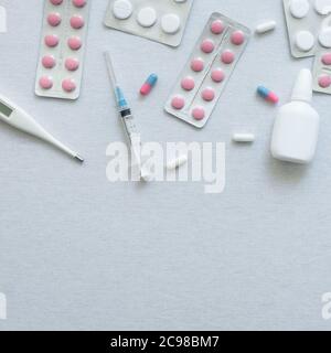 top view of thermometer, pills and nasal spray on white background Stock Photo