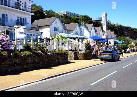 Shanklin, Isle of Wight, UK. July 18, 2020. Holidaymakers walking past seafront hotels and diners towards the cliff lift at Shanklin on the Isle of Wi Stock Photo