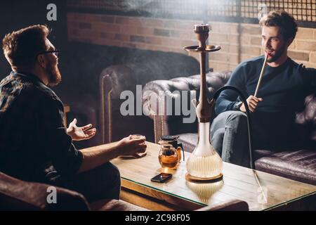 two cherful men having a conversation in the informal area. close up shot. friendship and companionship concept Stock Photo