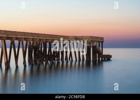 Sea pier with long exposure water Stock Photo