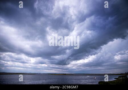28 July 2020, Mecklenburg-Western Pomerania, Kirchdorf: Dark rain cloud moves over the Baltic Sea off the island of Poel. Photo: Jens Büttner/dpa-Zentralbild/ZB Stock Photo