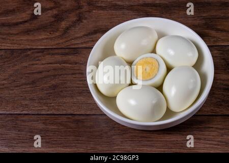 Boiled peeled eggs without shell on a background. Ingredients for cooking. Stock Photo