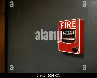 Manual Pull Down Fire Alarm on Gray wall Stock Photo
