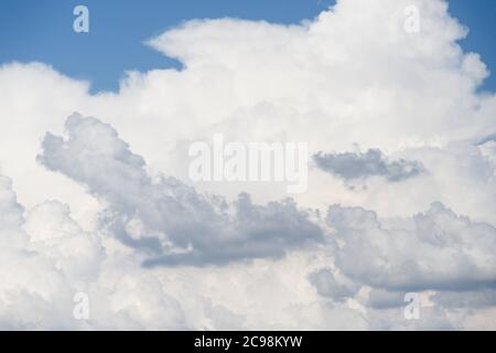 Blue sky with fluffy white and grey clouds, sky background Stock Photo
