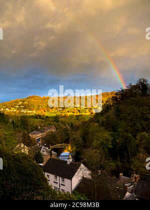 Rainbow and dramatic stormy sky over the village of Matlock Bath in the Derbyshire Peak District England UK Stock Photo