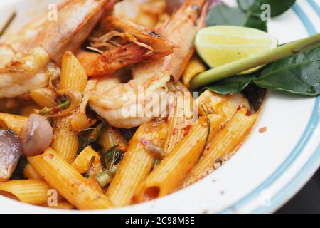 Creamy Tom Yum Goong Penne with lemon and Lime leaf Stock Photo