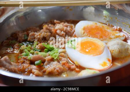 Minced pork noodles and boil egg with tom yum soup Stock Photo