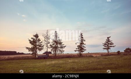 Peaceful rural landscape at sunset, retro color stylized picture. Stock Photo