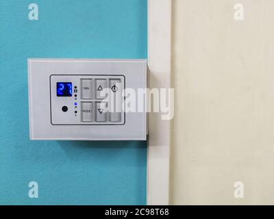 Room Thermostats on blue and white background. Stock Photo