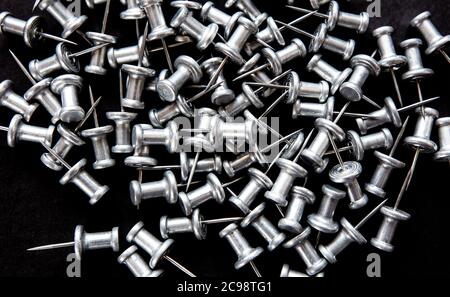 pins and stationery on a black background, closeup Stock Photo