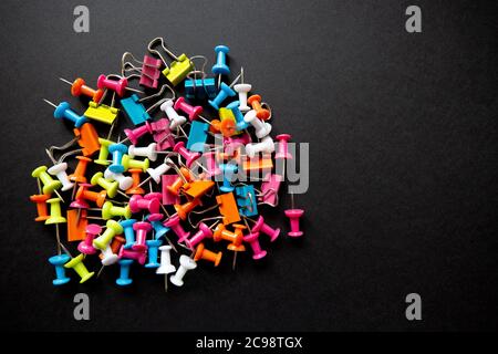 pins and stationery on a black background, closeup Stock Photo