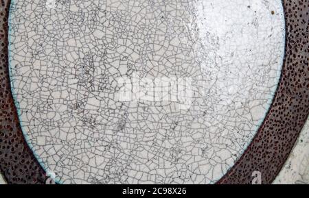 A crack pattern in the glaze of a ceramic plate., close up Stock Photo