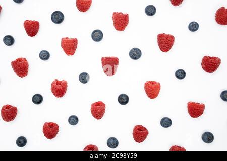Creative layout with blueberry and raspberry isolated on the white background. Top view. Flat lay pattern. Stock Photo