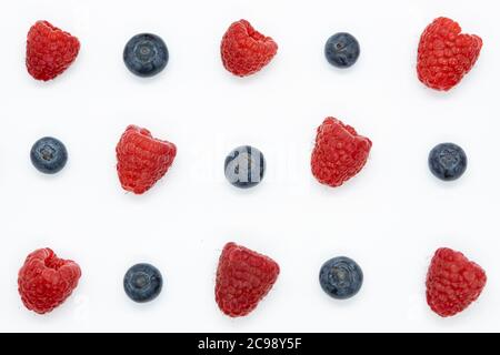 Creative layout with blueberry and raspberry isolated on the white background. Top view. Flat lay pattern. Stock Photo