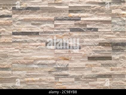 facing made with small rectangular stone tiles of non-uniform color.texture Stock Photo