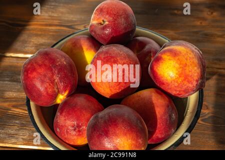 ripe peaches in an iron bowl close-up Stock Photo