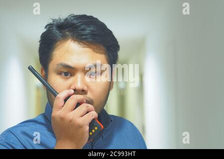 Man with a Walkie Talkie or Portable radio transceiver for communication Stock Photo