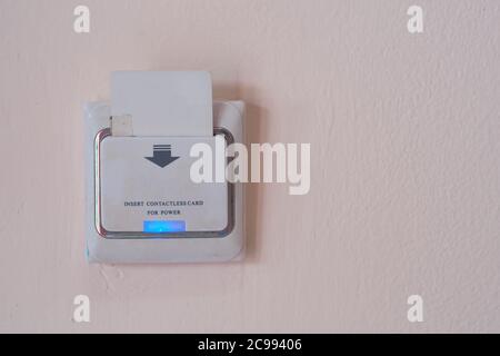 Insert Old key card in electronic lock and unlock   in hotel, Emergy Saving Switch system. Stock Photo
