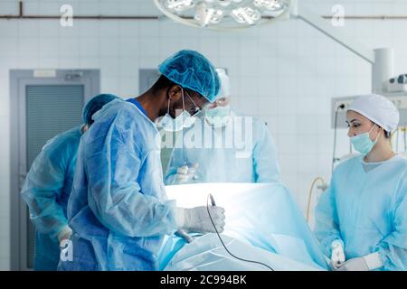 african man in glasses concentrataed on working in the hospital. side view photo Stock Photo