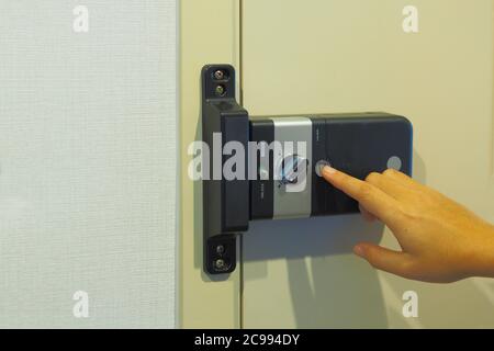 Women are using a key card to open the door to enter the room in the condominium. Security - Keycard Entry Systems Stock Photo