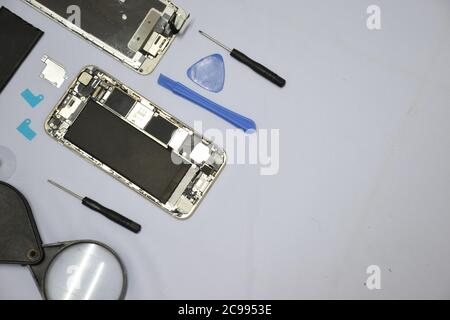 Soft focus to Tools for repairing smart phones on a white background - Change or replacement smart phones battery Stock Photo