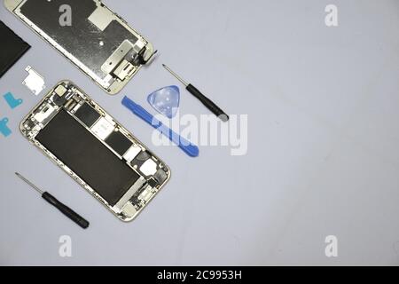 Soft focus to Tools for repairing smart phones on a white background - Change or replacement smart phones battery Stock Photo