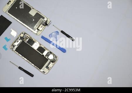 Soft focus to Tools for repairing smart phones on a white background - Change or replacement smart phones battery Stock Photo