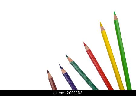 Six various colored wood pencil crayons placed on a white isolated paper background Stock Photo