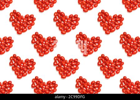 Pattern of small cherry tomatoes in shape of heart. Concept of love and symbol of healthy nutrition. Flat lay. Use for t-shirt, greeting cards, Stock Photo