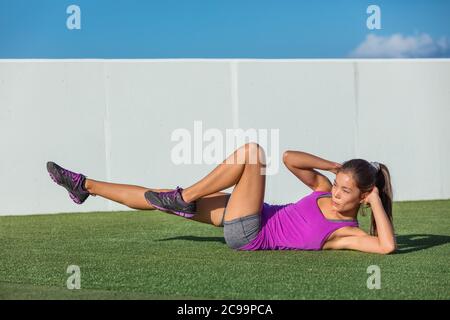 Exercise fitness woman training abs sit up at home. Asian girl doing bicycle crunch workout to train body core. Bodyweight floor exercises. Healthy Stock Photo