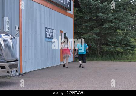 Two women walking into a business Stock Photo