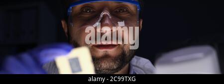 Worker holding microchip Stock Photo