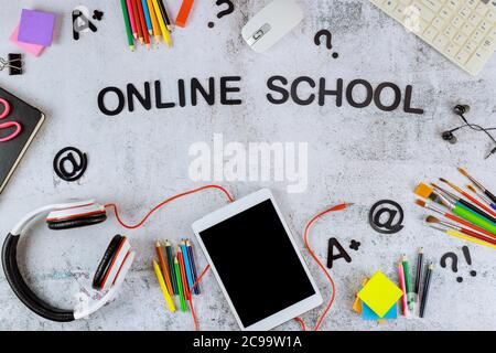 Digital tablet with black mockup screen for school education and art supplies on white background. Stock Photo