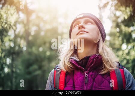Young woman hiking and going camping in nature Stock Photo