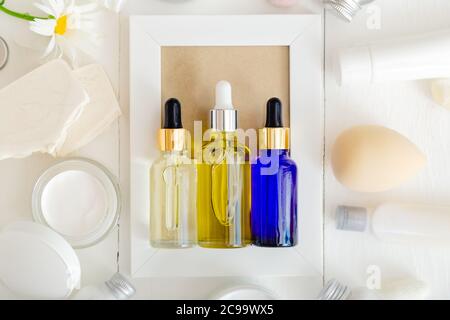 Serum oil dropper glass bottle set. Skincare hair treatment cosmetic for beauty face. Different types of oil and serum mockup on white background. Top Stock Photo