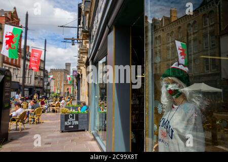 A mannequin modelling a face-mask with a Welsh flag design in a shop window in Cardiff city centre, July 2020. Stock Photo