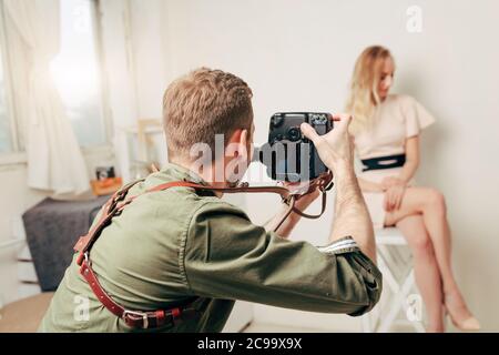 young man testing his new digital camera, technology concept, useful tool for photographer, blurred backgroung Stock Photo