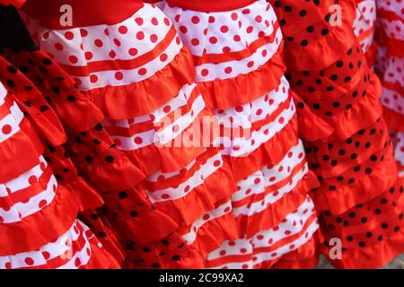 Closeup shot of traditional dotted red, white, and black flamenco dresses Stock Photo