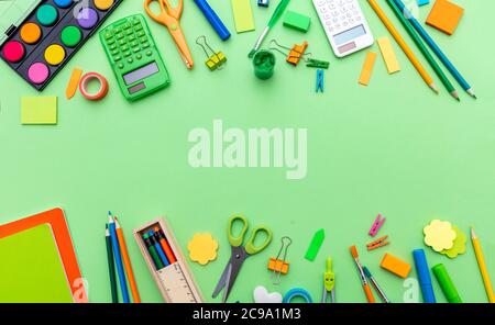 School supplies. Stationery double border on green color background, top view, copy space.  Education, Back to School, kids creativity concept Stock Photo