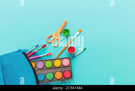 School supplies flat lay. Stationery on blue color background, top view, copy space.  Education, Back to School, kids creativity concept Stock Photo