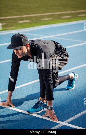 Sport and lifestyle. male runner on the start.side view shot. hobby, sport activity Stock Photo
